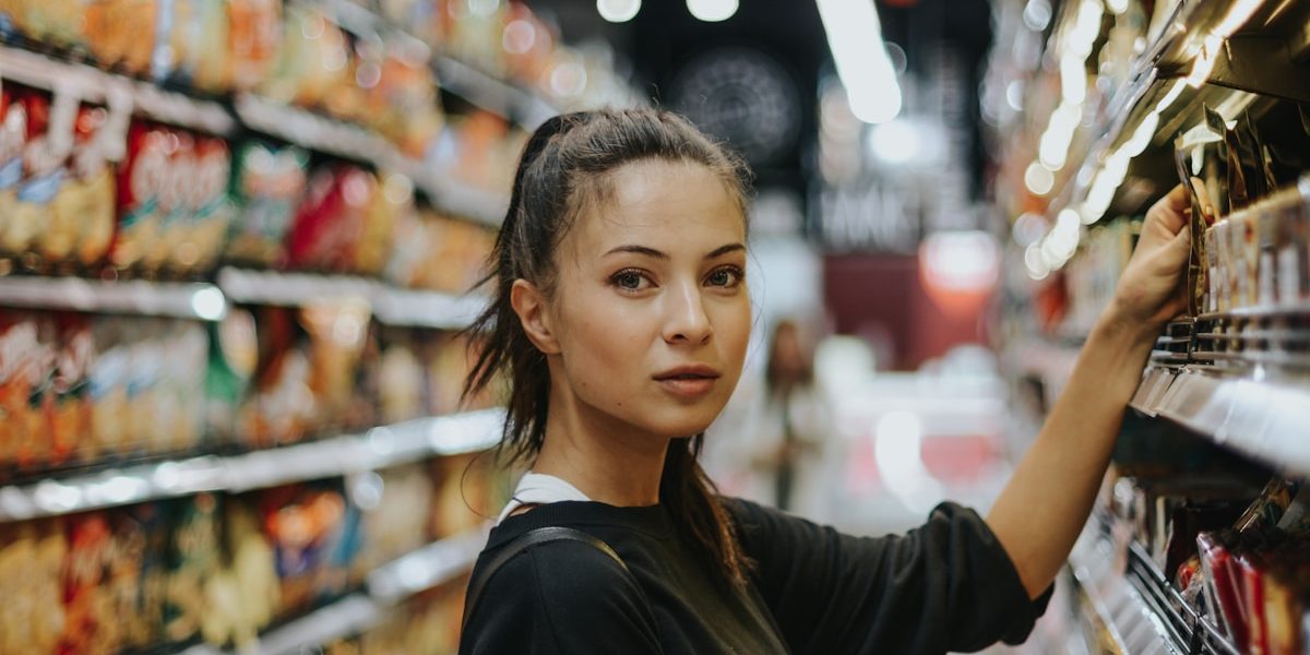 woman selecting packed food on gondola