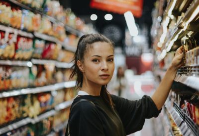 woman selecting packed food on gondola